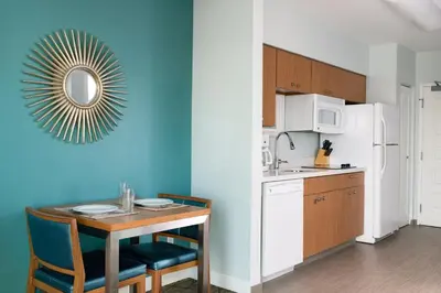 a kitchen with a table and a mirror on the wall at WorldMark Anaheim in Anaheim