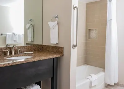 a bathroom with a tub and a sink and a bath tubermottermottermottermott at WorldMark Anaheim in Anaheim