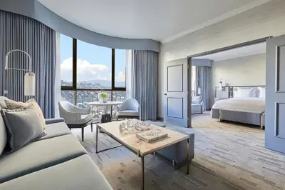 a hotel room with a bed and a couch and a table at Beverly Wilshire, Beverly Hills, A Four Seasons Hotel in Los Angeles