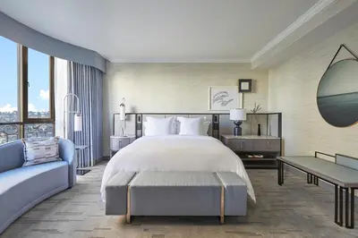 a bedroom with a large bed and a couch at Beverly Wilshire, Beverly Hills, A Four Seasons Hotel in Los Angeles