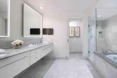 a white bathroom with two sinks and a shower at Four Seasons Hotel Westlake Village in Westlake Village