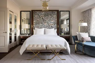 a bedroom with a large bed and a blue chair at Four Seasons Hotel Westlake Village in Westlake Village