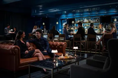 a group of people sitting in chairs in a bar at Four Seasons Hotel Westlake Village in Westlake Village