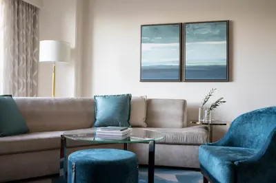 a living room with a couch and two chairs at Four Seasons Hotel Westlake Village in Westlake Village