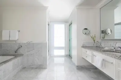 a white bathroom with two sinks and a shower at Four Seasons Hotel Westlake Village in Westlake Village