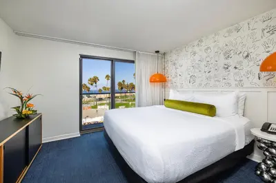 a hotel room with a large bed and a window at Hotel Erwin Venice Beach in Los Angeles