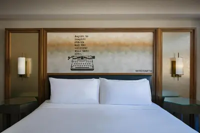 a bed with two white pillows in a room at Hotel Dena, Pasadena Los Angeles, a Tribute Portfolio Hotel in Pasadena