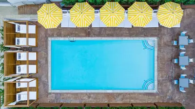 an overhead view of a swimming pool with umbrellas at Hotel Dena, Pasadena Los Angeles, a Tribute Portfolio Hotel in Pasadena