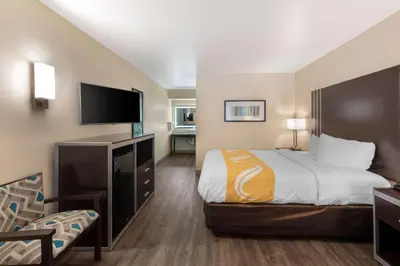 a hotel room with a bed and a flat screen tv at Quality Inn & Suites Camarillo-Oxnard in Camarillo