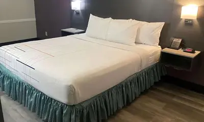 a large white bed in a hotel room at La Quinta Inn by Wyndham Bakersfield South in Bakersfield