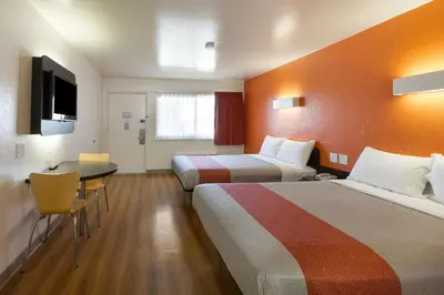 a hotel room with two beds and a desk at Motel 6-Claremont, CA in Claremont