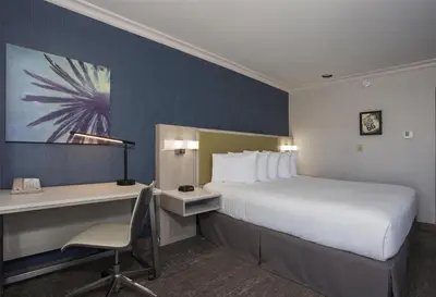a hotel room with a bed and a desk and a computer at SureStay Hotel by Best Western Santa Monica in Los Angeles