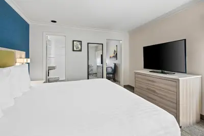 a hotel room with a large bed and a flat screen tv at SureStay Hotel by Best Western Santa Monica in Los Angeles