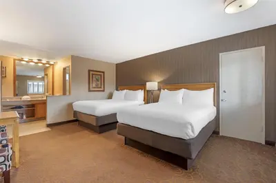 a hotel room with two beds and a bathroom at Best Western Plus Pavilions in Anaheim
