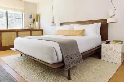 a bedroom with a large white bed and a window at Silver Lake Pool & Inn in Los Angeles