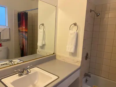 a bathroom with a sink and a mirror at Villa Park Motel in Orange
