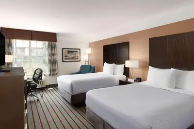 a hotel room with two beds and a desk at La Quinta by Wyndham Bakersfield North in Bakersfield