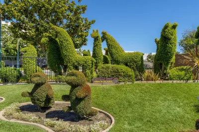 two statues of bears in a park at Best Western Plus Stovall's Inn in Anaheim