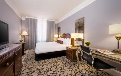 a hotel room with a bed and a desk at The Biltmore Los Angeles in Los Angeles