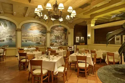 a restaurant with tables and chairs and a chandelier at The Biltmore Los Angeles in Los Angeles