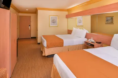 a hotel room with two beds and a television at H3 Inn & Suites - LAX Airport - Los Angeles in Inglewood