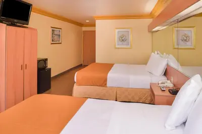 a hotel room with two beds and a television at H3 Inn & Suites - LAX Airport - Los Angeles in Inglewood