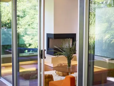a living room with a table and a fireplace at Palms Place in Los Angeles