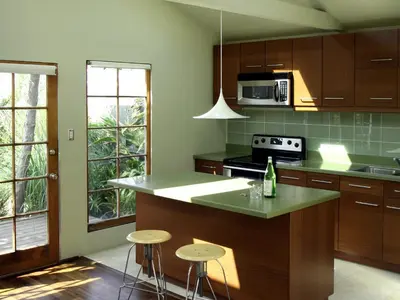 a kitchen with a counter and stools in it at Venice Place in Los Angeles