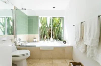 a bathroom with a tub and a toilet and a window at Venice Place in Los Angeles