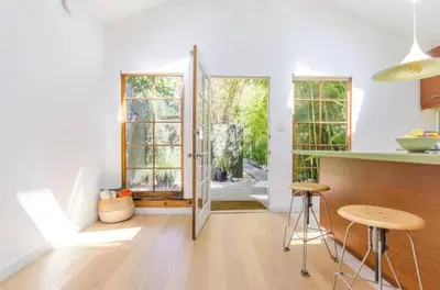 a kitchen with a table and two stools in a room at Venice Place in Los Angeles
