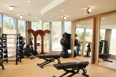 a gym with a lot of exercise equipment and mirrors at Santa Monica Proper Hotel, a Member of Design Hotels in Los Angeles