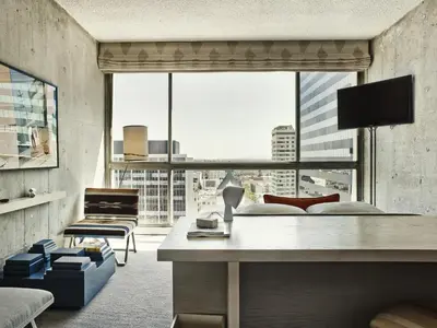 a living room with a large window with a view at The LINE Hotel LA in Los Angeles