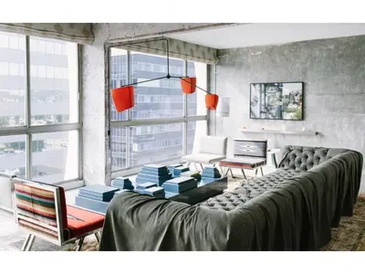 a living room with a couch and a table at The LINE Hotel LA in Los Angeles