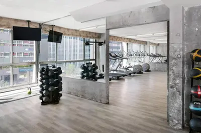a gym with a bunch of treadmills and a large window at The LINE Hotel LA in Los Angeles