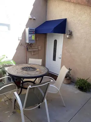 a patio with a table and chairs in front of a building at Comfortable Luxury Studio in Los Angeles