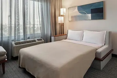 a hotel room with a bed and a window at Courtyard Long Beach Airport in Long Beach