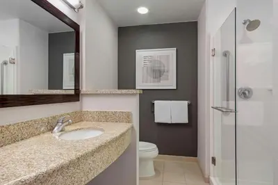 a bathroom with a sink and a toilet and a mirror at Courtyard Long Beach Airport in Long Beach