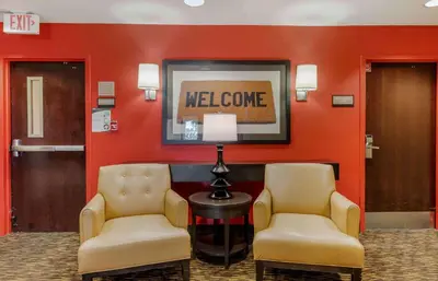 a waiting room with two chairs and a welcome sign at Extended Stay America Suites - Orange County - Huntington Beach in Huntington Beach