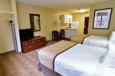 a hotel room with two beds and a flat screen tv at Extended Stay America Suites - Orange County - Huntington Beach in Huntington Beach