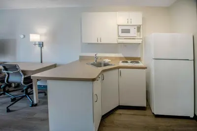 a kitchen with a sink and a white refrigerator at Extended Stay America Suites - Orange County - Anaheim Convention Center in Anaheim