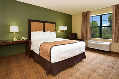 a hotel room with a large bed and a window at Extended Stay America Suites - Orange County - Anaheim Convention Center in Anaheim