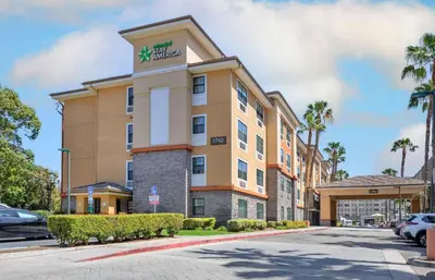a hotel building with a sign on top of it at Extended Stay America Suites - Orange County - Anaheim Convention Center in Anaheim