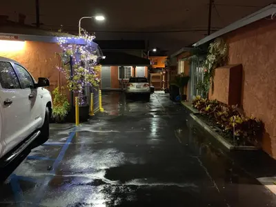 a car parked in a parking lot at night at SunLight Motel Long Beach in Long Beach