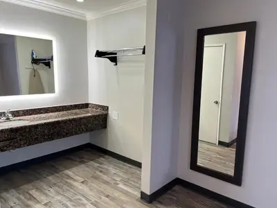 a bathroom with a sink and a mirror at Cloud 9 Inn LAX in Inglewood