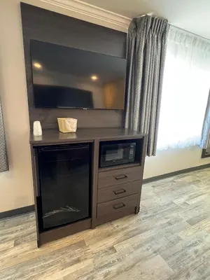 a large entertainment center with a flat screen tv at Cloud 9 Inn LAX in Inglewood