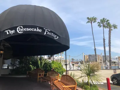 a restaurant with a black umbrella and chairs and palm trees at Fantastic Marina View in Front of My Window! in Los Angeles