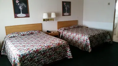 a hotel room with two beds in a room at Economy Inn Motel in Sylmar