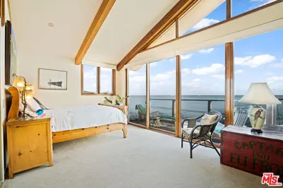 a bedroom with a bed and a view of the ocean at Villa Rylee in Malibu