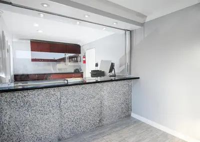 a kitchen with a counter with a mirror at Sea Rock Inn - Long Beach in Long Beach
