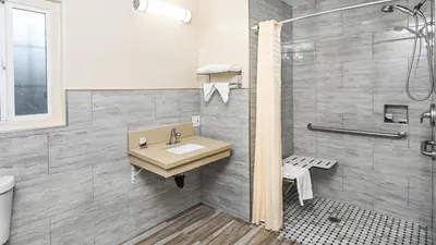 a bathroom with a sink and a shower at Sea Rock Inn - Long Beach in Long Beach